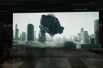 Sci-fi spaceship hovering over a futuristic city skyline.