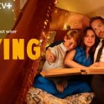 Cast of Apple TV+ series Trying sitting together with pizza in a cozy setting.
