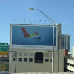 A billboard in Miami shows a cartoon of a person riding a shark with an octopus on their finger.
