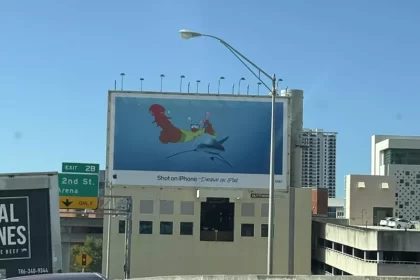 A billboard in Miami shows a cartoon of a person riding a shark with an octopus on their finger.