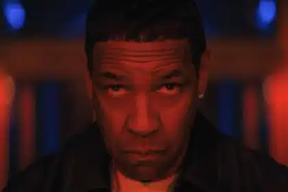 Denzel Washington stares intensely under red lighting.