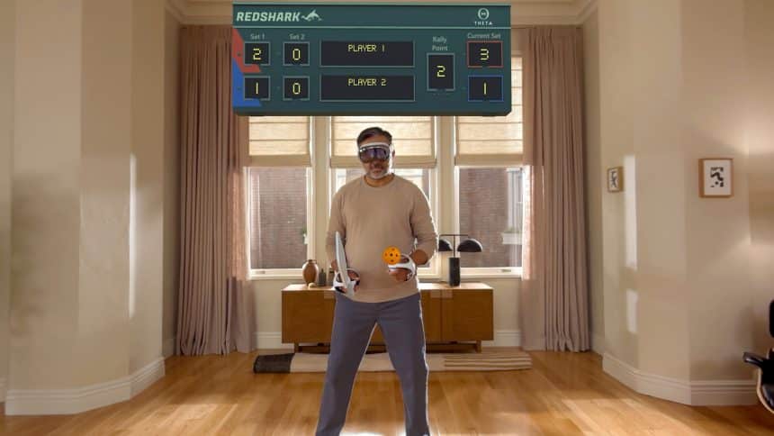 Man playing a virtual game using Apple Vision Pro headset and controllers.
