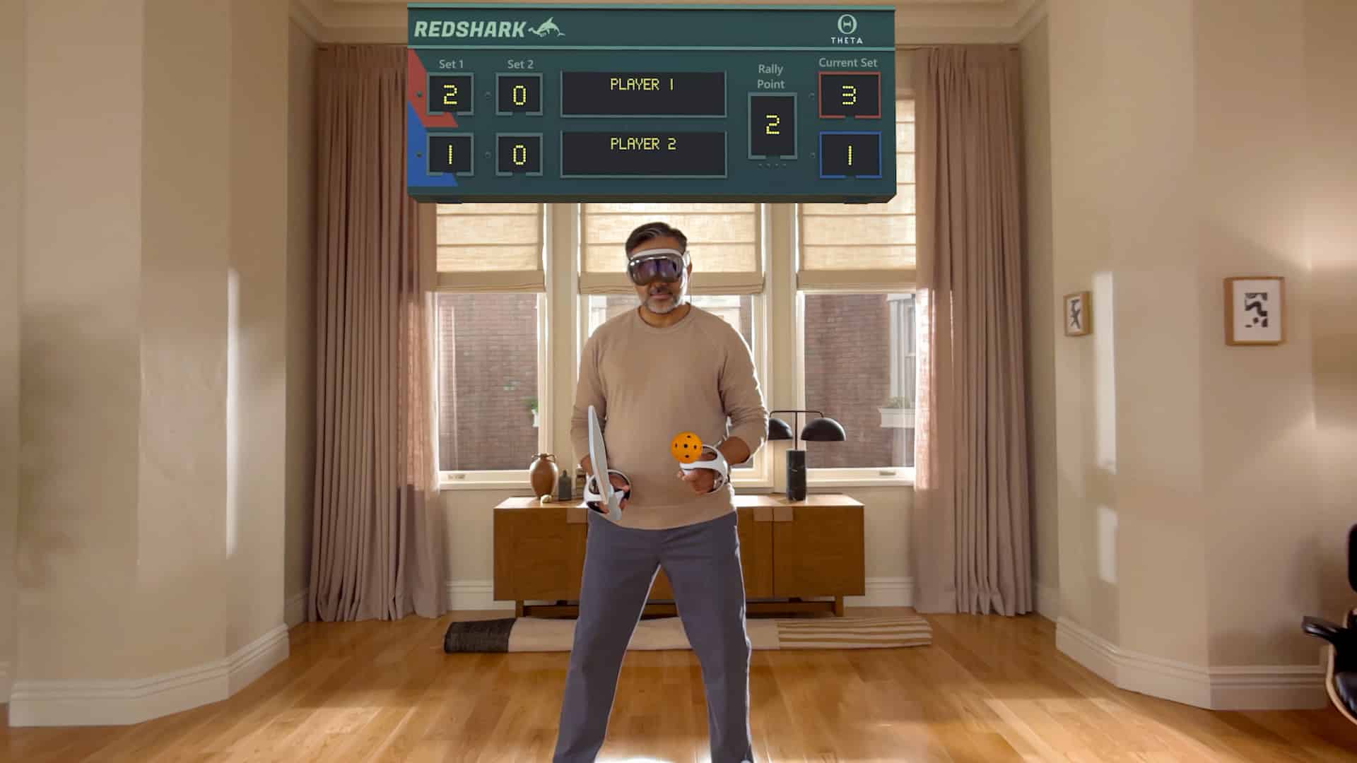 Man playing a virtual game using Apple Vision Pro headset and controllers.