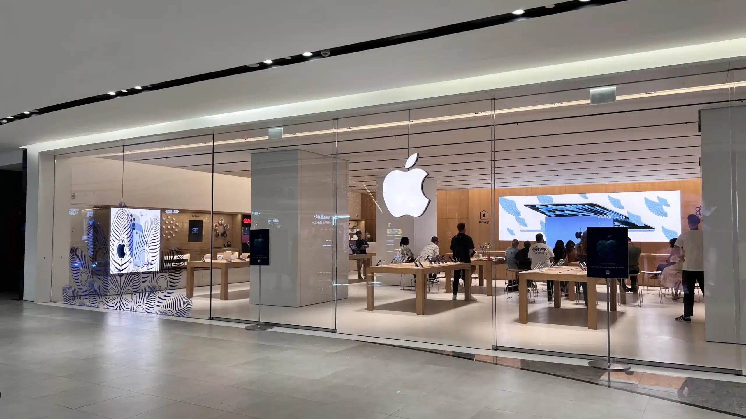 Apple Store at Phoenix Mall with glass front and customers inside.