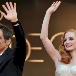 Ben Stiller and Jessica Chastain wave at a red carpet event.