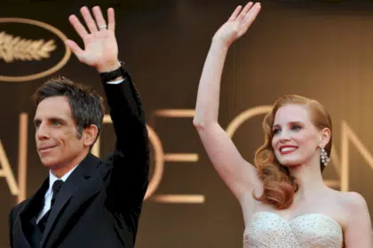 Ben Stiller and Jessica Chastain wave at a red carpet event.