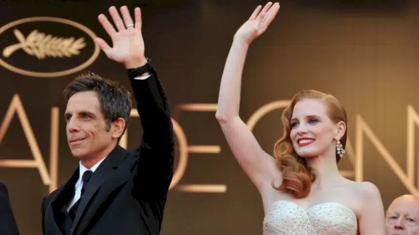 Ben Stiller and Jessica Chastain wave at a red carpet event.