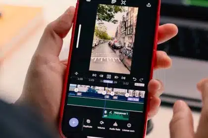 Person editing a video on an iPhone using Adobe Premiere.