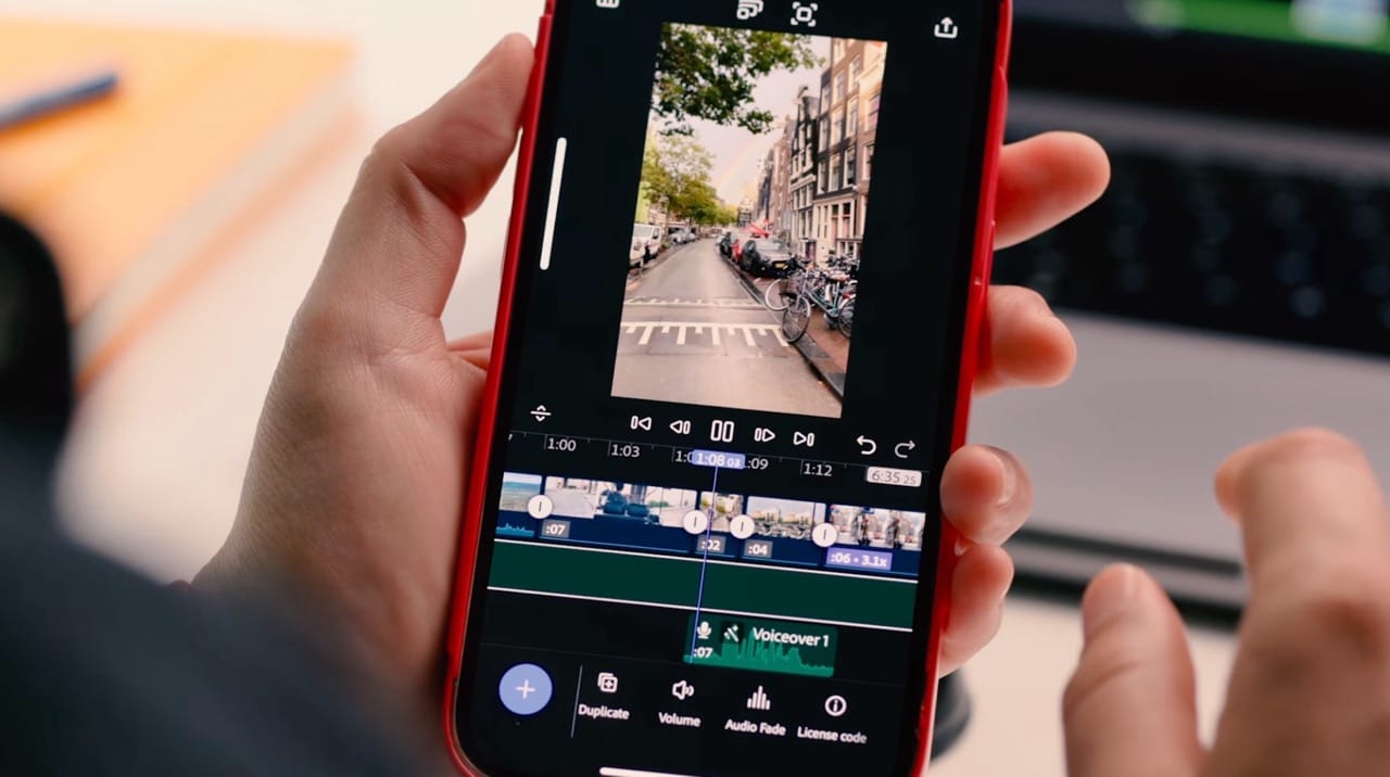Person editing a video on an iPhone using Adobe Premiere.