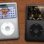 Two iPod Classics displaying clickwheel games on wooden surface.