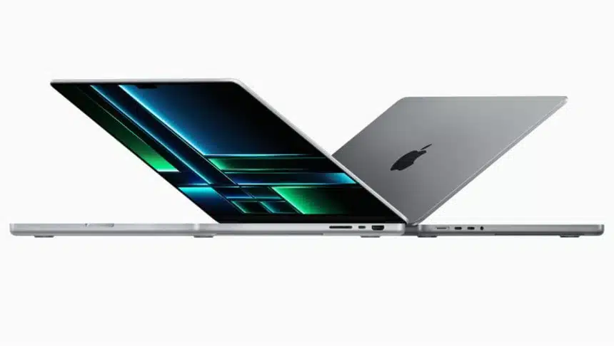 Two MacBook Pro laptops half-open, facing opposite directions.