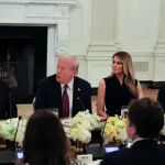 Donald Trump, Melania Trump, and tech leaders sit at a dinner table.