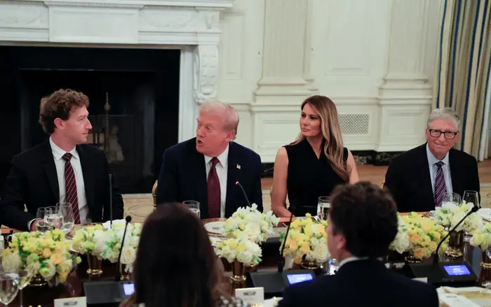 Donald Trump, Melania Trump, and tech leaders sit at a dinner table.