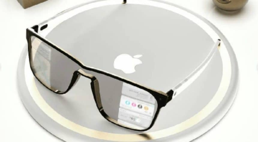 Concept image of Apple Glasses placed on a silver circular surface with the Apple logo.