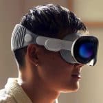A person wearing an Apple Vision Pro headset in a well-lit room.