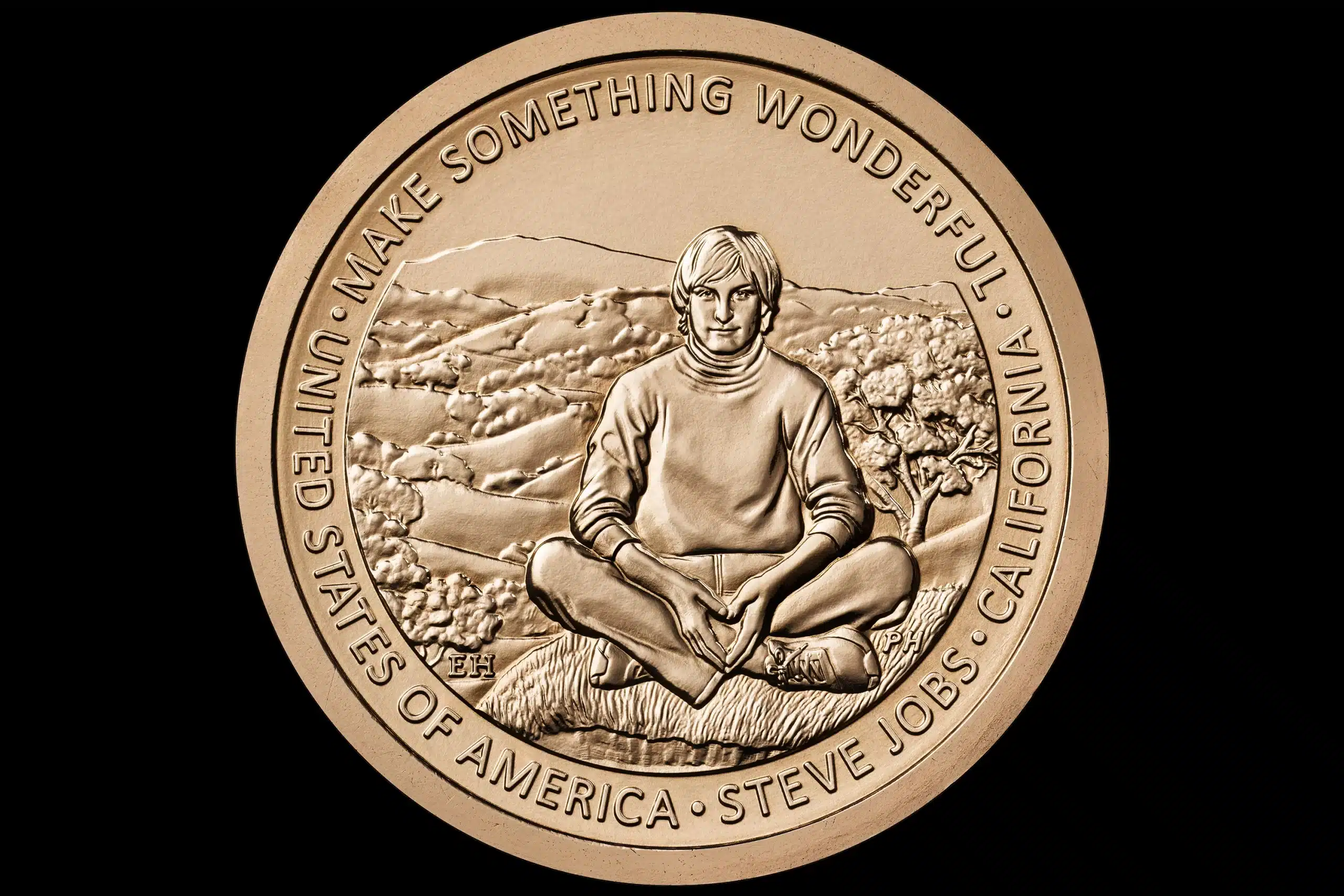 Gold coin featuring Steve Jobs sitting cross-legged with the inscription “Make Something Wonderful.”