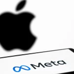 Meta logo displayed on a smartphone screen with a blurred Apple logo in the background.