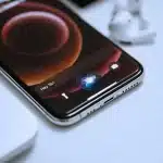 Close-up of an iPhone with Siri activated on the screen.