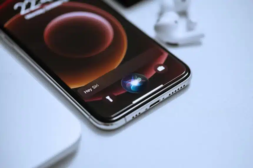 Close-up of an iPhone with Siri activated on the screen.