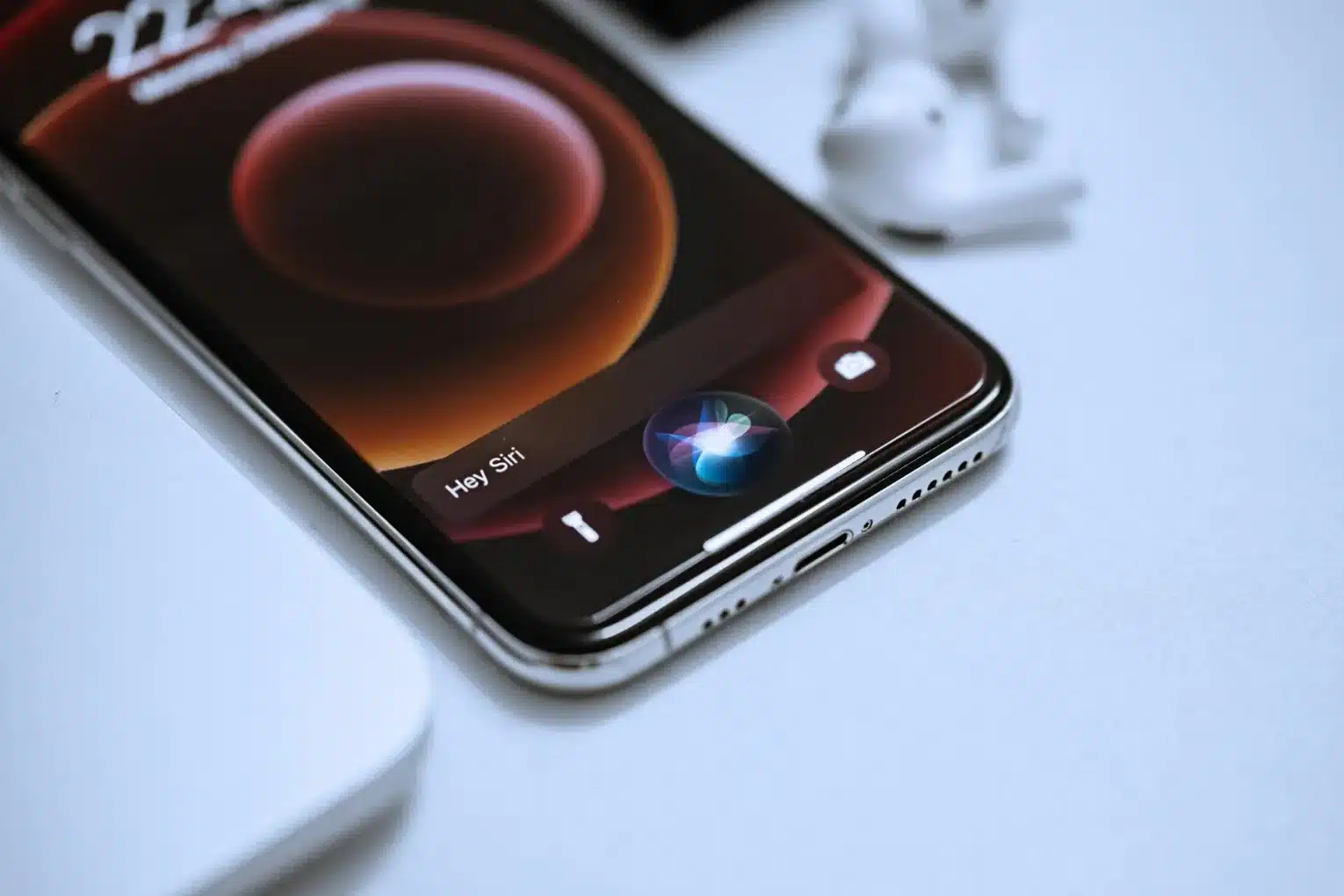 Close-up of an iPhone with Siri activated on the screen.