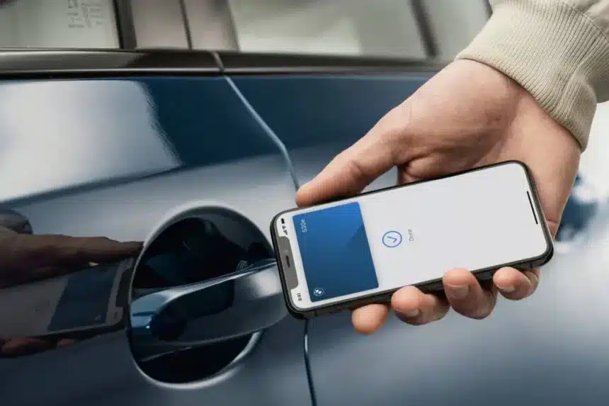A person unlocking a car using an iPhone with Apple Car Key.