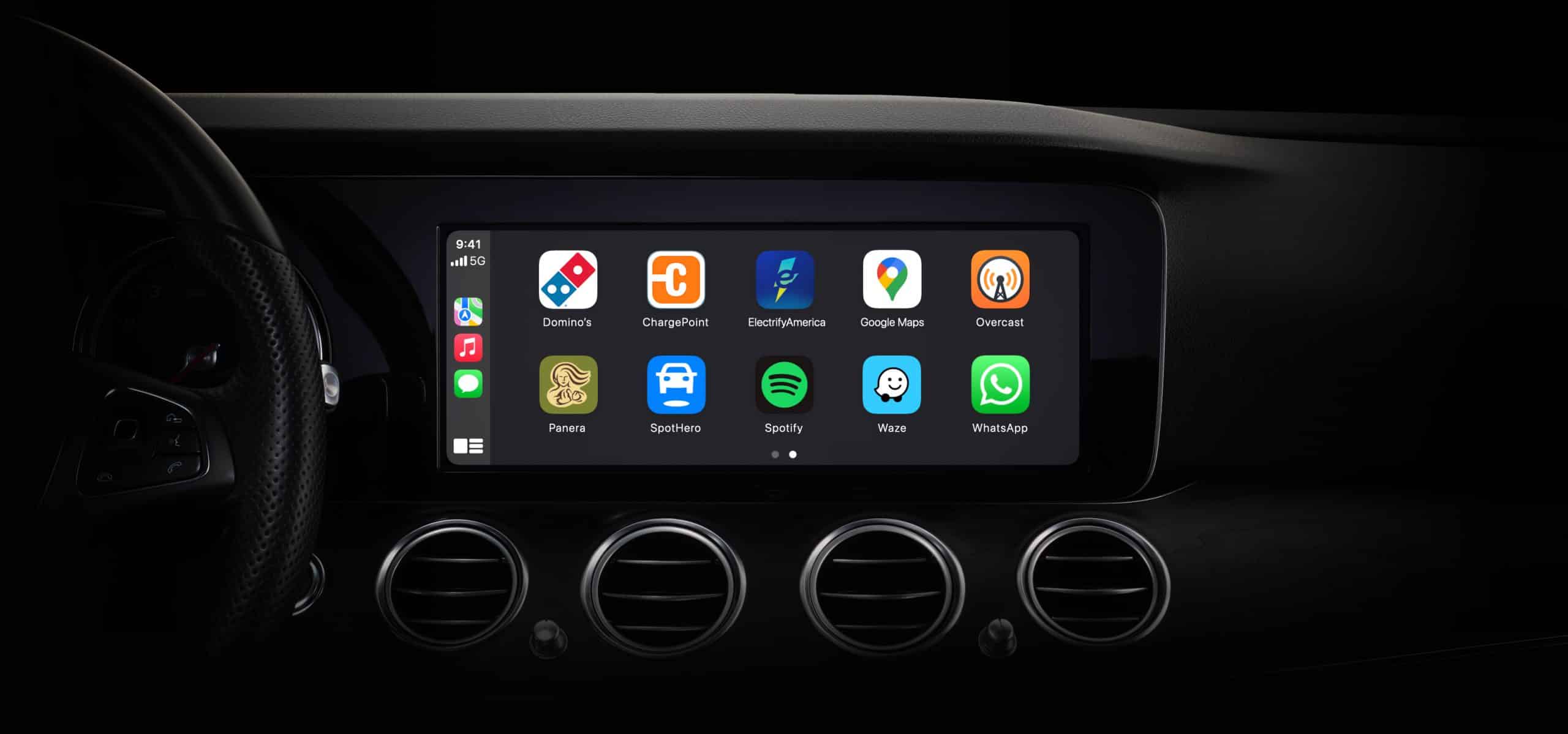 Car dashboard display showing Apple CarPlay apps on the screen.
