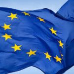 European Union flag waving against a blue sky.