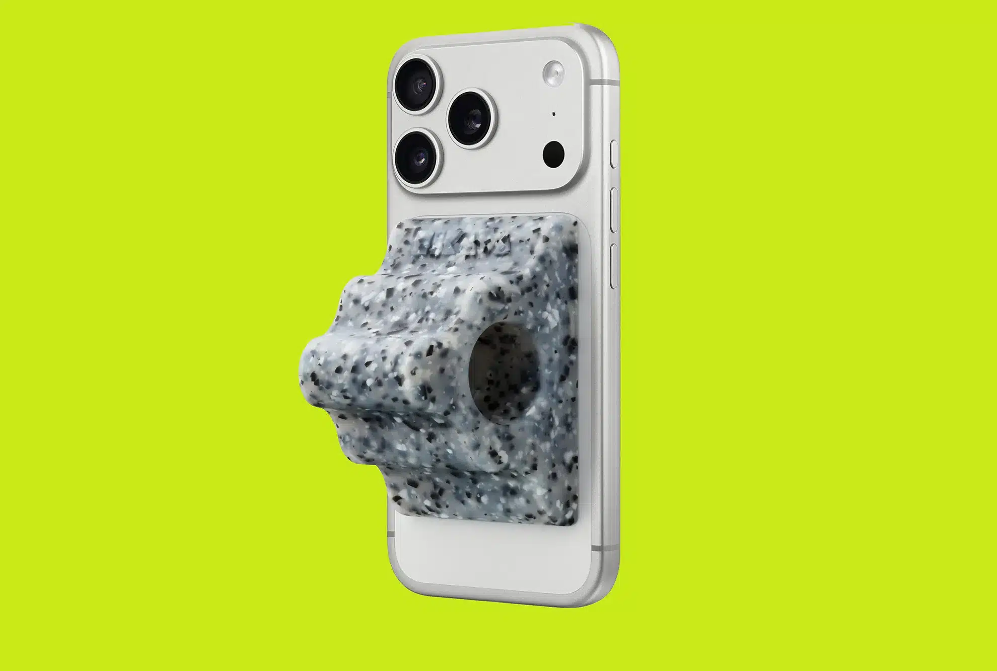 iPhone with a speckled gray grip attached on a bright green background.