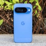 Blue Google Pixel phone standing upright outdoors.
