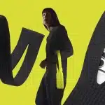 Person wearing a long knit iPhone pouch with large looping straps.