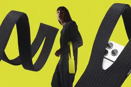 Person wearing a long knit iPhone pouch with large looping straps.