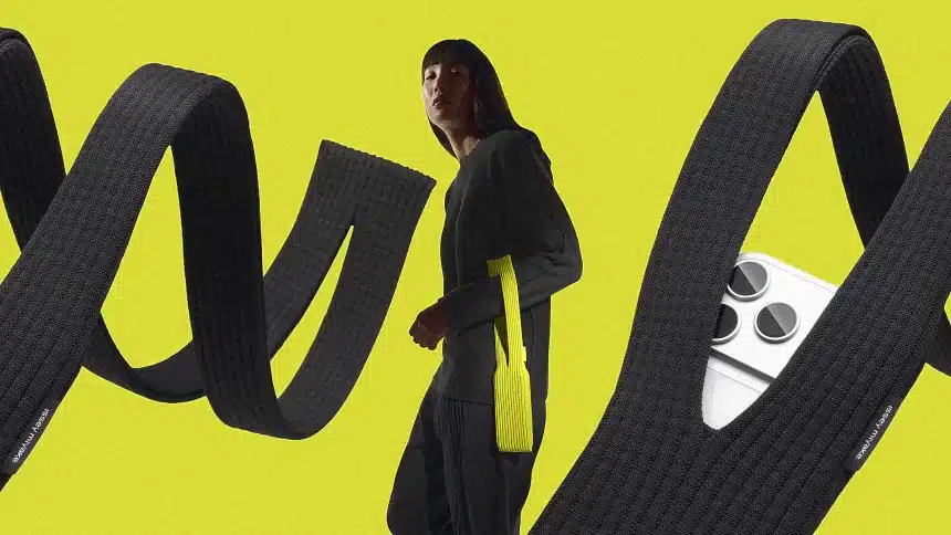 Person wearing a long knit iPhone pouch with large looping straps.