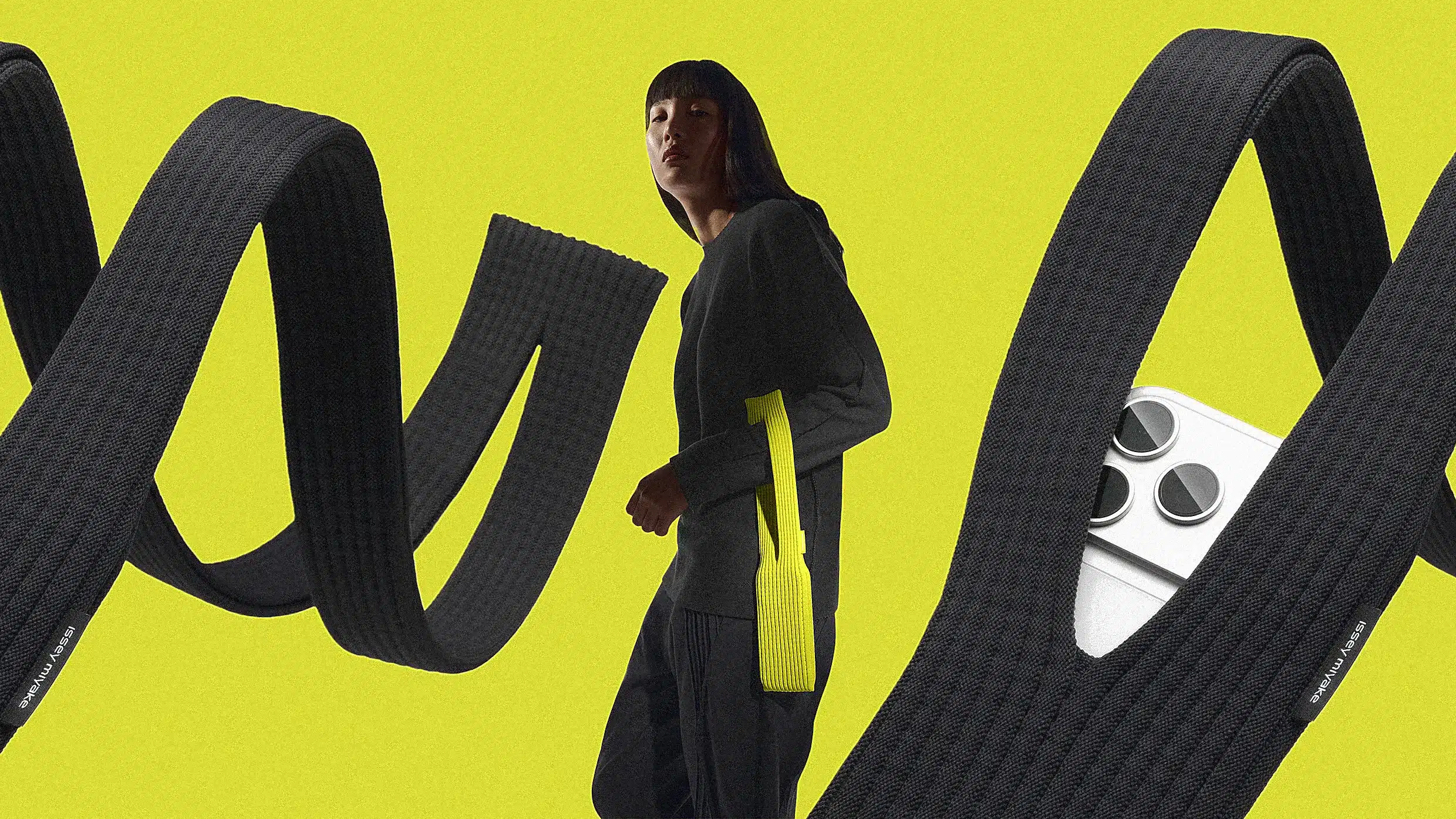 Person wearing a long knit iPhone pouch with large looping straps.