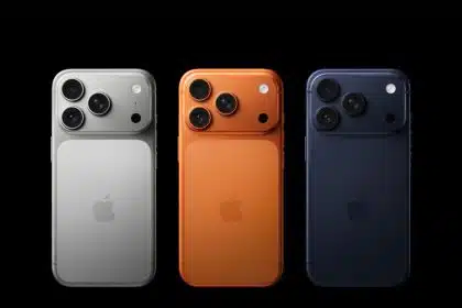 Three iPhone models in silver, orange, and navy blue shown from the back.