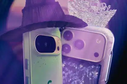 Two smartphones dressed as characters, with one wearing a witch hat and the other a tiara.