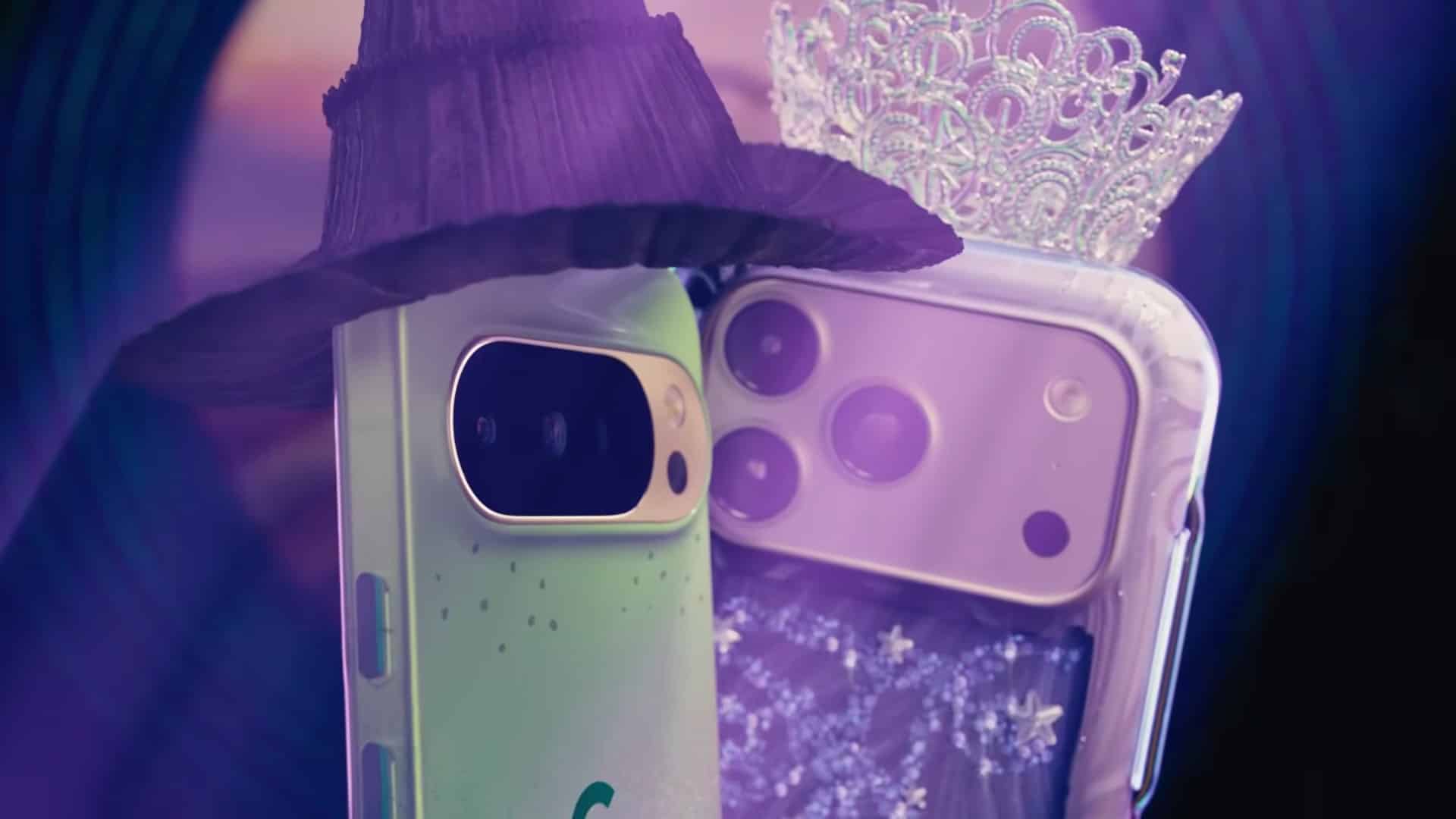Two smartphones dressed as characters, with one wearing a witch hat and the other a tiara.