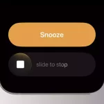 iPhone screen showing the new “slide to stop” alarm feature in iOS 26.1.