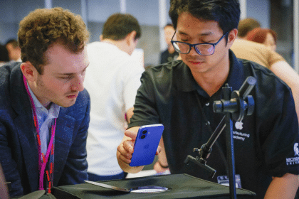Apple Manufacturing Academy staff demonstrating a smartphone inspection process.