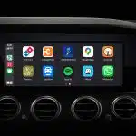 Car dashboard screen displaying Apple CarPlay apps.