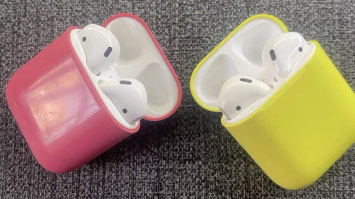 Pink and yellow AirPods charging case prototypes side by side.