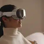 Person wearing Apple Vision Pro headset at home.