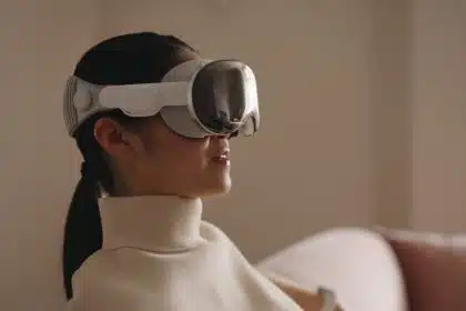 Person wearing Apple Vision Pro headset at home.