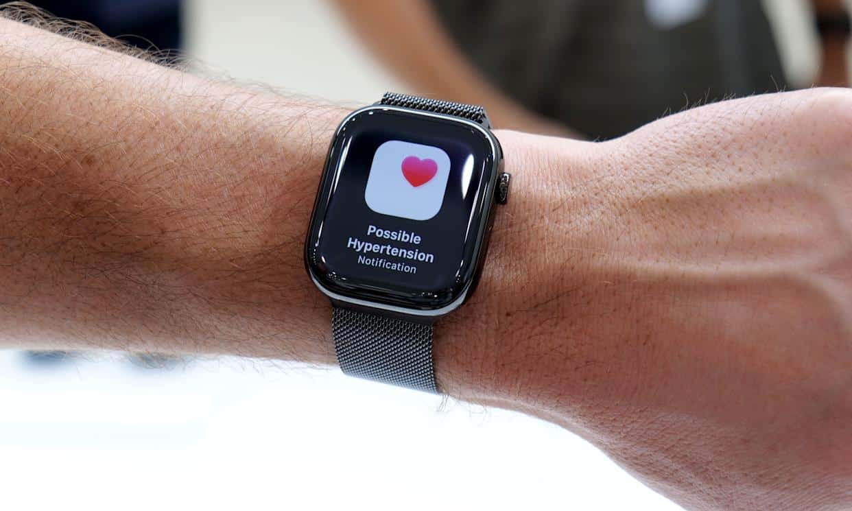 Apple Watch showing a possible hypertension notification on the screen.