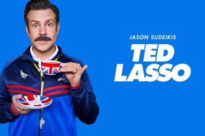 Jason Sudeikis as Ted Lasso holding a teacup and saucer.