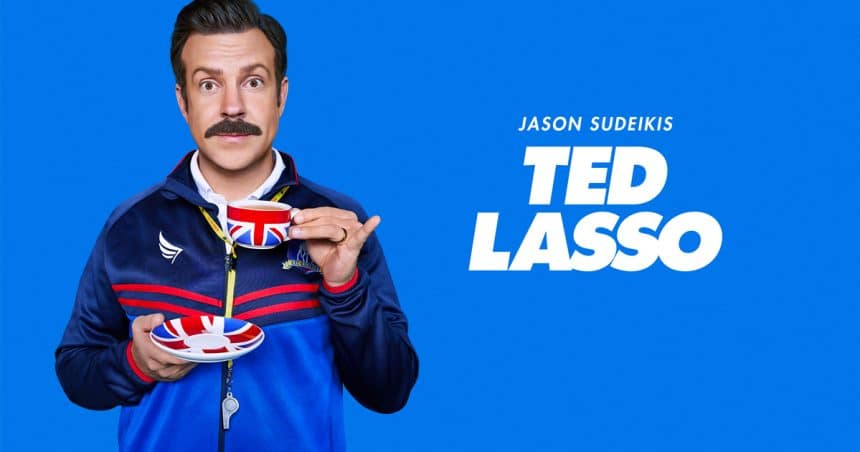 Jason Sudeikis as Ted Lasso holding a teacup and saucer.