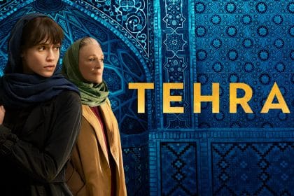 Two lead characters from the series Tehran standing in front of blue mosaic tiles.