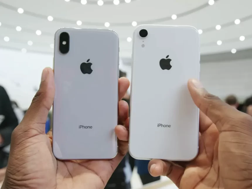 Two iPhones held side by side, showing their backs.