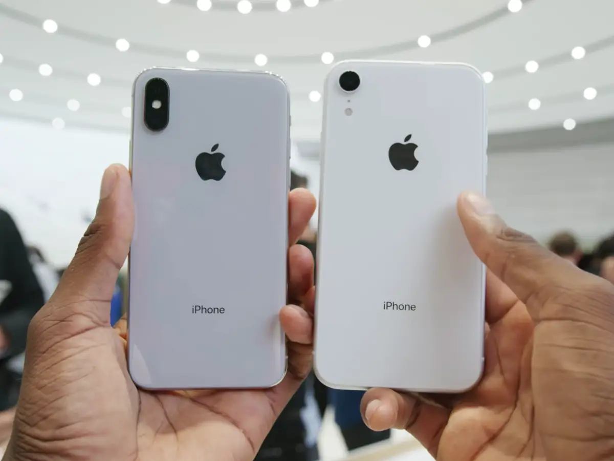 Two iPhones held side by side, showing their backs.