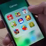 iPhone screen showing a folder of mobile game apps.