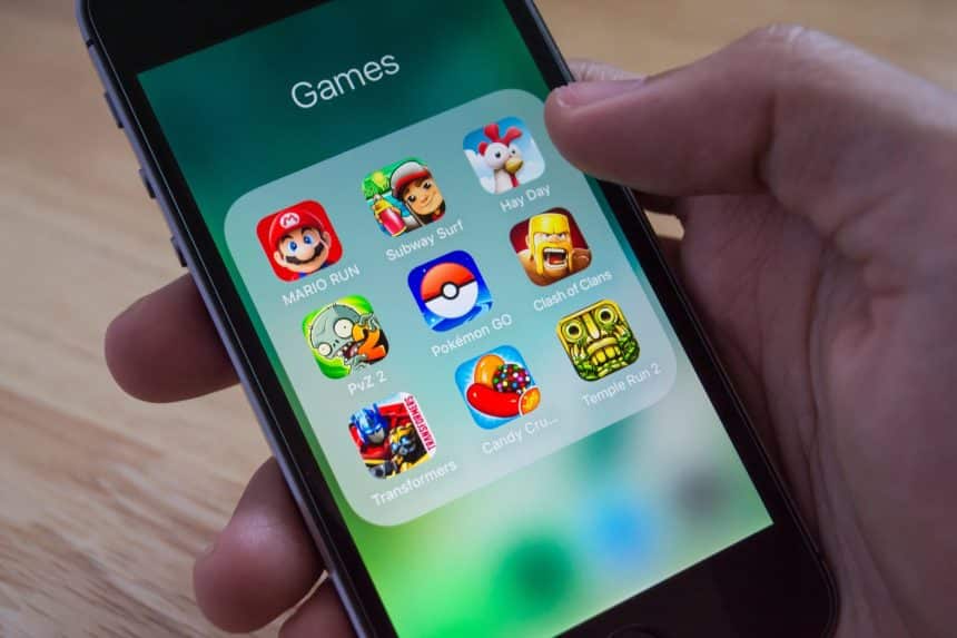 iPhone screen showing a folder of mobile game apps.
